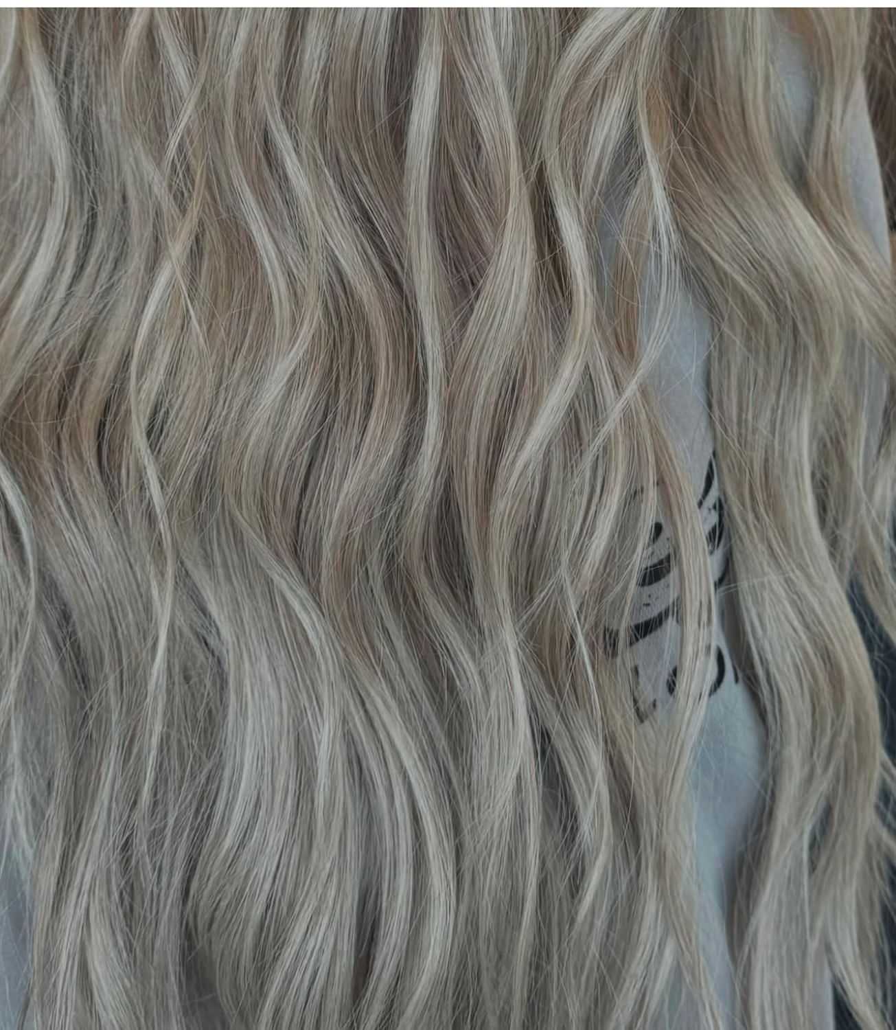 Wavy light brown and blonde hair close-up, showcasing textured and natural-looking waves.